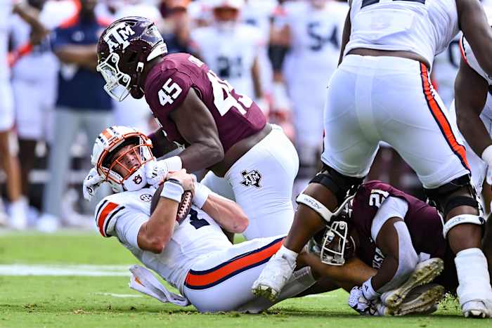 Sep 23, 2023; College Station, Texas, USA; Texas A&M Aggies linebacker Edgerrin Cooper (45) sacks Auburn Tigers quarterback Payton Thorne (1) during the first half at Kyle Field.